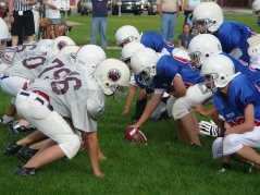 Children lining up to begin a play in a football game (Dineen, 2013). 