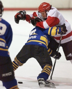 Minor hockey body check (Vaughan, 2001).